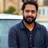 Akhil D. next to compact vehicle